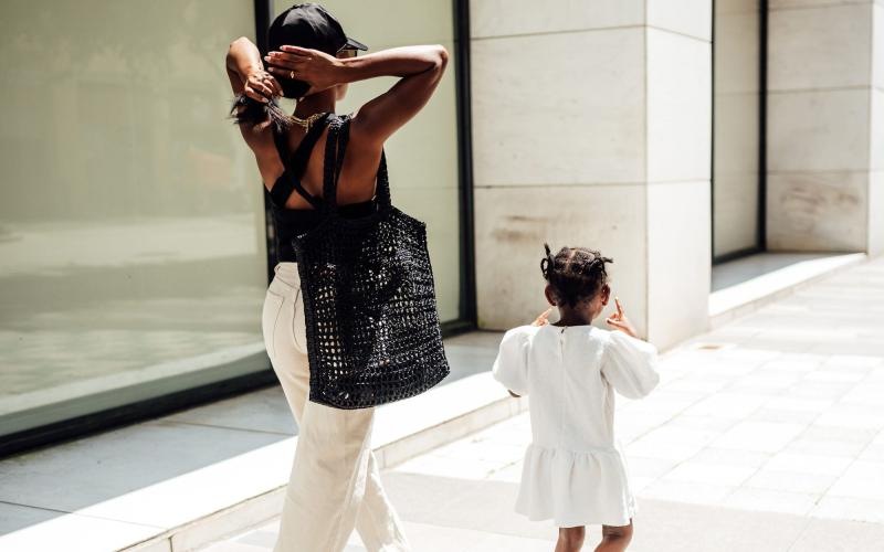 a woman walking with her child